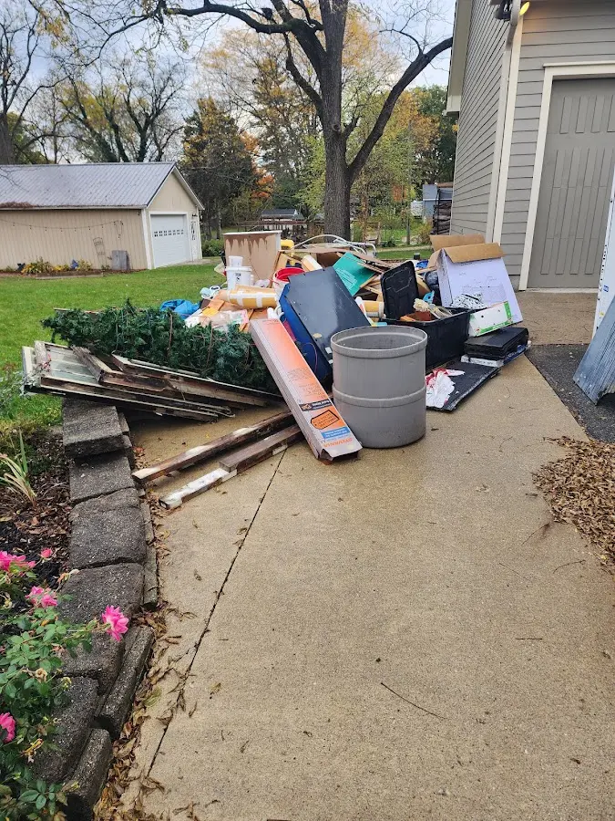 Dumpster being loaded with debris for 12 Yard Dumpster Rental in Pendleton